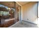 Screened patio with brick flooring and view into the living area with beautiful hardwood floors at 13777 Forest Lake Dr, Largo, FL 33771