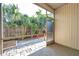 Enclosed patio featuring brick flooring and a view of the fenced backyard with mature trees and garden space at 13777 Forest Lake Dr, Largo, FL 33771