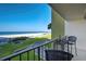 A balcony overlooking green space and a white sandy beach at 1480 Gulf Blvd # 103, Clearwater Beach, FL 33767