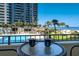 Balcony view featuring a table, chairs, and distant ocean views with nearby pool at 1480 Gulf Blvd # 103, Clearwater Beach, FL 33767