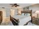 Comfortable bedroom featuring a wooden bed frame, soft lighting, and neutral decor at 1480 Gulf Blvd # 103, Clearwater Beach, FL 33767