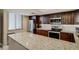 Modern kitchen features granite countertops, stainless steel appliances, and sleek dark wood cabinets at 1480 Gulf Blvd # 103, Clearwater Beach, FL 33767