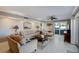Comfortable living room featuring tile flooring, a ceiling fan, and sliding glass doors to a balcony at 1480 Gulf Blvd # 103, Clearwater Beach, FL 33767
