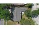 Aerial view of the home showcasing the roof and surrounding lush, mature trees and landscaping at 15118 Brushwood Dr, Tampa, FL 33624