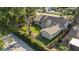 Aerial view of a home with a spacious backyard, mature trees, and a serene setting at 15118 Brushwood Dr, Tampa, FL 33624