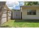 View of backyard with shed and partial house view with window at 15118 Brushwood Dr, Tampa, FL 33624