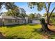 Expansive backyard with mature trees and a patio, great for entertaining or enjoying nature at 15118 Brushwood Dr, Tampa, FL 33624