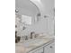 Bright bathroom with a marble countertop, bronze faucet and oval mirror at 15118 Brushwood Dr, Tampa, FL 33624