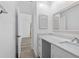 Bright bathroom featuring white cabinets, a decorative mirror, and a sleek countertop at 15118 Brushwood Dr, Tampa, FL 33624