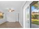 Spacious bedroom with wood-look flooring, a ceiling fan, and sliding glass doors to the outside at 15118 Brushwood Dr, Tampa, FL 33624