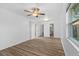 Spacious bedroom with wood-look flooring, a ceiling fan, and access to the bathroom at 15118 Brushwood Dr, Tampa, FL 33624