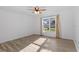 The spacious bedroom features wood-look floors, a ceiling fan, large windows and neutral paint at 15118 Brushwood Dr, Tampa, FL 33624