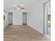 Bright bedroom featuring wood-look flooring, a ceiling fan, and sliding glass doors to the outside at 15118 Brushwood Dr, Tampa, FL 33624