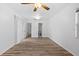 Bright bedroom featuring wood-look flooring, ceiling fan and access to an ensuite bathroom at 15118 Brushwood Dr, Tampa, FL 33624