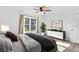 Cozy bedroom with a ceiling fan, a bright window, and a stylish dresser offering ample storage at 15118 Brushwood Dr, Tampa, FL 33624