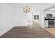 Bright dining room with wood floors and chandelier lighting, conveniently located next to the well-equipped kitchen at 15118 Brushwood Dr, Tampa, FL 33624