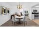 Bright dining area featuring wood floors and is staged with modern furniture, with access to the kitchen at 15118 Brushwood Dr, Tampa, FL 33624