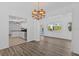 Open dining room with natural light and wood floors, connects to the kitchen and outdoor patio area at 15118 Brushwood Dr, Tampa, FL 33624