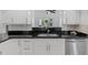 Modern kitchen features granite counters, stainless steel appliances, white cabinets and mosaic tile backsplash at 15118 Brushwood Dr, Tampa, FL 33624