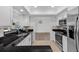 Bright kitchen with granite countertops, stainless appliances, tile backsplash and view of dining and living room at 15118 Brushwood Dr, Tampa, FL 33624