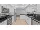 Updated kitchen featuring white cabinets, granite countertops, stainless steel appliances, and tile flooring at 15118 Brushwood Dr, Tampa, FL 33624