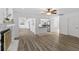 Open concept living area with a view of the kitchen and modern gray-toned floor at 15118 Brushwood Dr, Tampa, FL 33624