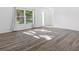 Bright living room featuring a large window, fresh white paint and a modern gray-toned floor at 15118 Brushwood Dr, Tampa, FL 33624
