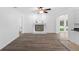 Cozy living room featuring a fireplace with a modern gray-toned floor and bright light at 15118 Brushwood Dr, Tampa, FL 33624