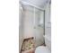 Bathroom shower with mosaic floor, glass doors and white tiling at 1524 Lemon St, Clearwater, FL 33756