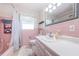 Bathroom featuring a pink-tiled wall, a bathtub with a curtain, and a vanity at 1524 Lemon St, Clearwater, FL 33756