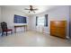 Open bedroom with a chair, dresser, desk, ceiling fan, and terrazzo flooring at 1524 Lemon St, Clearwater, FL 33756