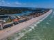 Beautiful aerial view of oceanfront condos, pristine beach, and scenic coastline with waterways, and the open ocean at 19440 Gulf Blvd # 306, Indian Shores, FL 33785