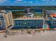 Aerial view of beachfront condo building and pool offering easy access to the beach at 19440 Gulf Blvd # 306, Indian Shores, FL 33785