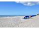 Bright beach scene featuring the ocean and blue lounge chairs at 19440 Gulf Blvd # 306, Indian Shores, FL 33785