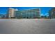 Beachside condo building featuring a light blue exterior with balconies and a stunning oceanfront location at 19440 Gulf Blvd # 306, Indian Shores, FL 33785