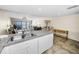 Open concept kitchen with adjacent living area and balcony overlooking the beach at 19440 Gulf Blvd # 306, Indian Shores, FL 33785