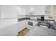 Clean kitchen featuring white appliances, granite countertops, and ample cabinet space at 19440 Gulf Blvd # 306, Indian Shores, FL 33785