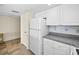 Bright kitchen featuring white cabinets, gray countertops and tile flooring at 19440 Gulf Blvd # 306, Indian Shores, FL 33785