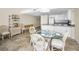 Bright living and dining area with wicker furniture and a glass table, creating a welcoming coastal vibe at 19440 Gulf Blvd # 306, Indian Shores, FL 33785