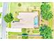 Aerial view showcasing a meticulously landscaped property with a pool, golf, and lush greenery at 2250 Mountain Ash Way, New Port Richey, FL 34655