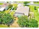 A bird's-eye view of the property, featuring a screened-in pool, mini putting green, and fenced-in backyard at 2250 Mountain Ash Way, New Port Richey, FL 34655