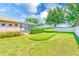 A private backyard featuring a putting green and screened-in pool offers outdoor enjoyment at 2250 Mountain Ash Way, New Port Richey, FL 34655