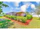 Backyard featuring a screened-in pool and meticulously maintained landscaping, creating a serene outdoor oasis at 2250 Mountain Ash Way, New Port Richey, FL 34655