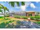A charming backyard with a screen-enclosed pool and well-manicured greenery at 2250 Mountain Ash Way, New Port Richey, FL 34655