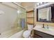 Well-lit bathroom featuring a glass shower door, vanity, decorative shelf, and neutral tones at 2250 Mountain Ash Way, New Port Richey, FL 34655
