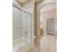 Modern bathroom with a glass-enclosed shower and tiled floor at 2250 Mountain Ash Way, New Port Richey, FL 34655