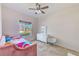 Bright bedroom with a pink velvet bed and neutral wall color at 2250 Mountain Ash Way, New Port Richey, FL 34655