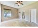 Bedroom features a window and a door to the bathroom at 2250 Mountain Ash Way, New Port Richey, FL 34655
