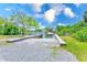 Concrete boat ramp with wooden railing that leads to a scenic waterway at 2250 Mountain Ash Way, New Port Richey, FL 34655