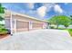 Spacious three-car garage, lush landscaping, and a beautiful yard enhance this charming home's appeal at 2250 Mountain Ash Way, New Port Richey, FL 34655